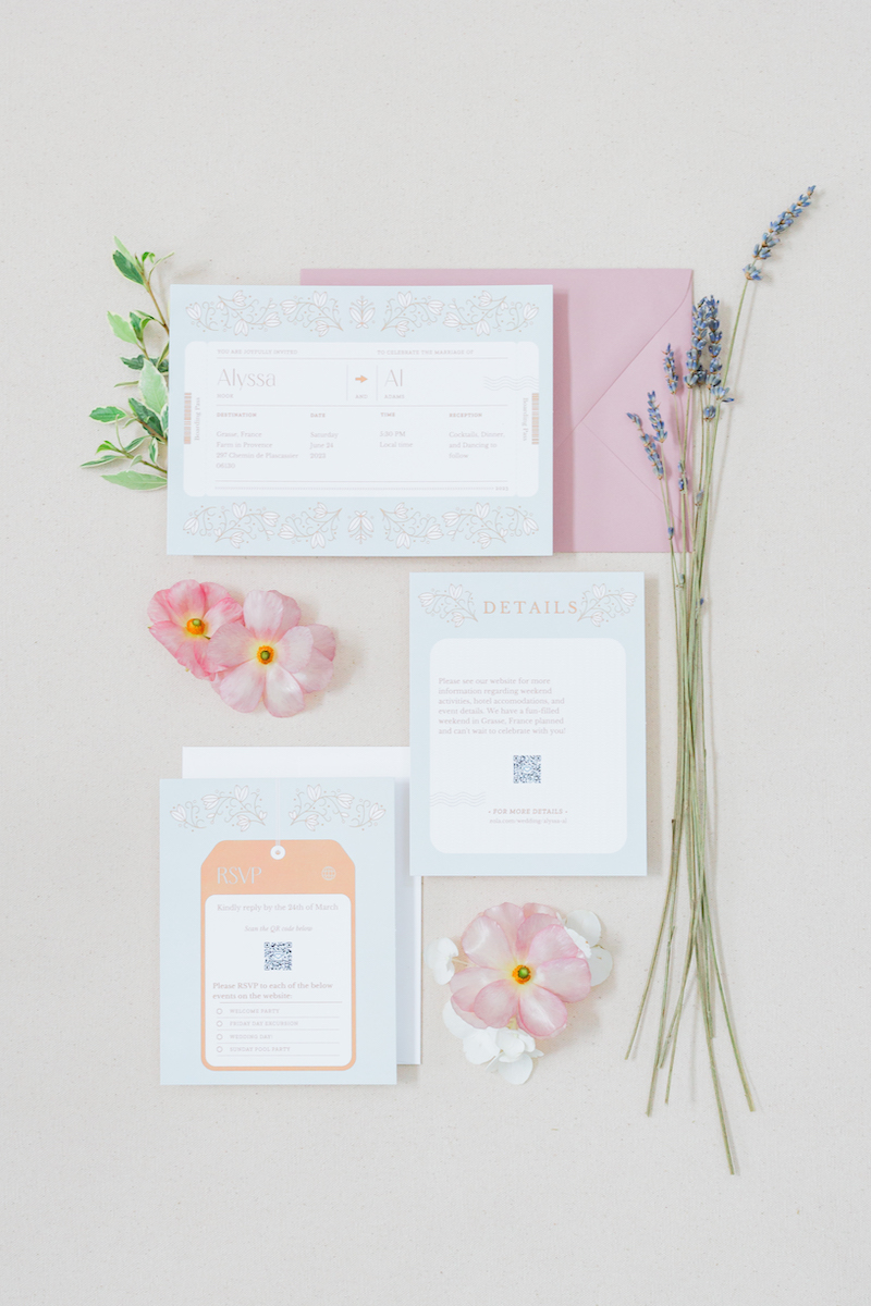 Wedding invitation set with RSVP card, details card, and pink envelope. Decorated with pink flowers, green leaves, and lavender sprigs on a beige background.