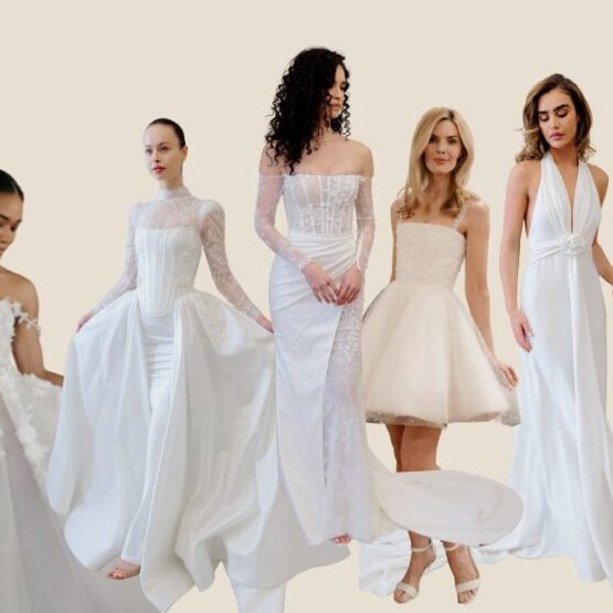 Five women wearing different styles of white wedding dresses stand against a plain light background.